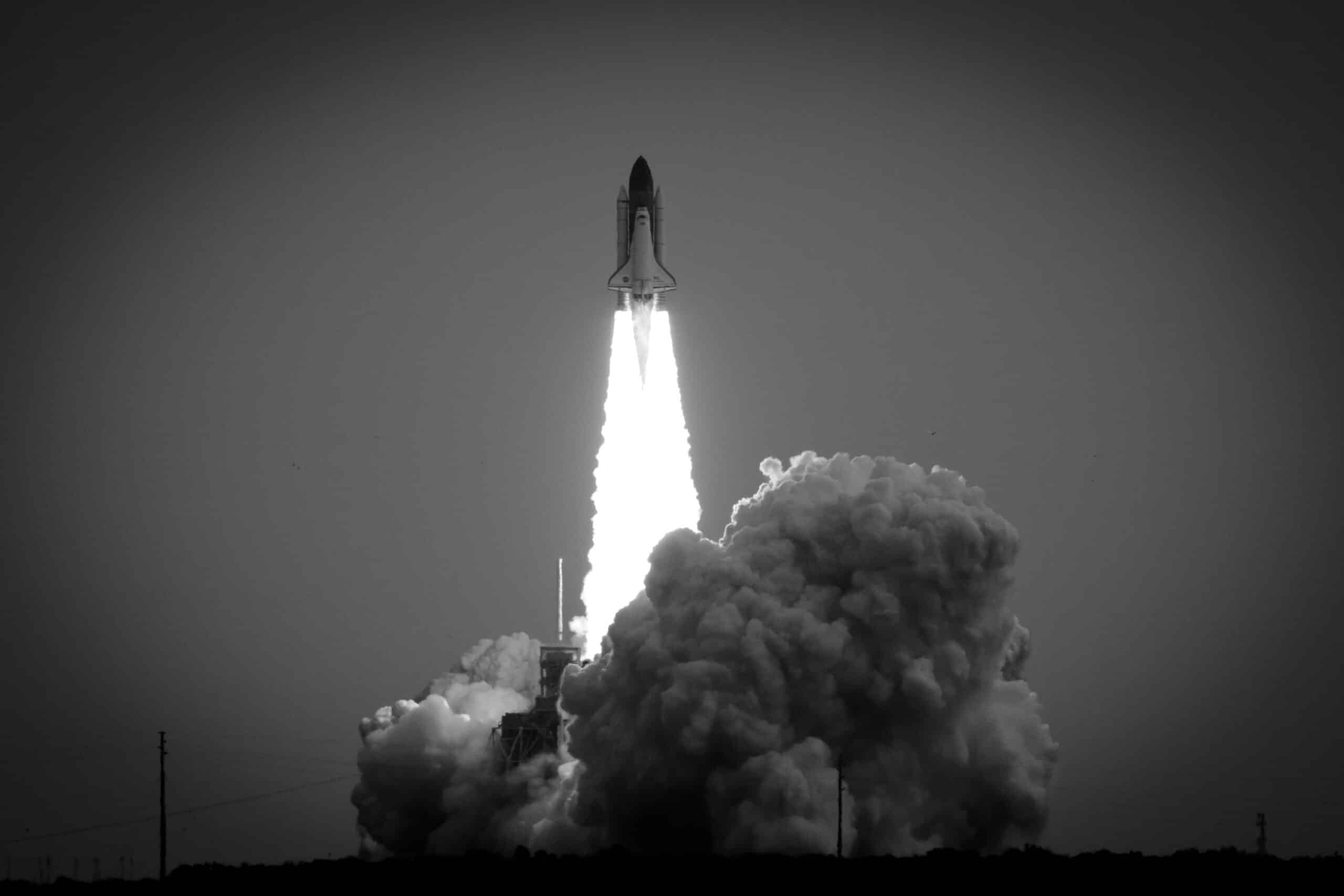 A black and white photo of the space shuttle launch.